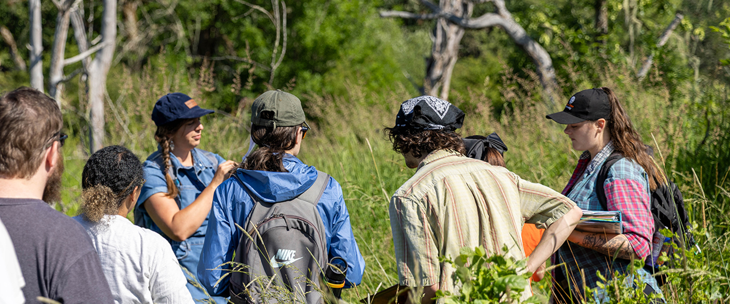 Students in a field class listening to instructor
