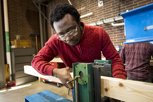 researcher works with timber in lab