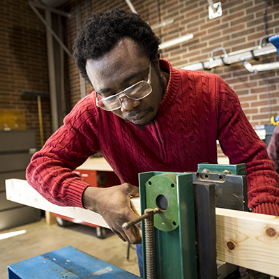 researcher works with timber in lab