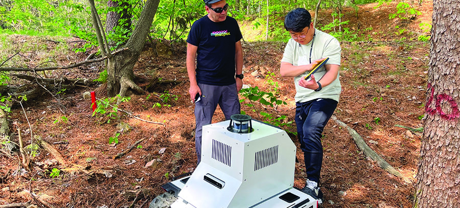 Assistant Professor Heesung Woo (right) conducts autonomous driving field tests while capturing 3D point cloud maps with a developed forestry robot system.