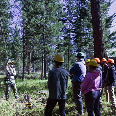 Micah Schmidt, OSU Extension fire specialist for the northeast region, provides tree-climbing instruction to the Northwest Youth Corps’ Community Wildfire Protection Corps crew at the OSU Oberteuffer Research and Education Forest in Union County.