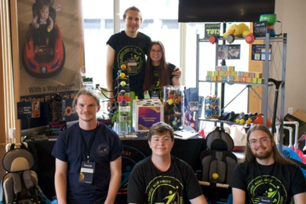 The members of PNW Assistive Technology in front of their table at InventOR.