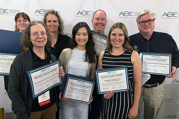 Members of the OSU Extension Communications office (from left) Ezraelle McLachlain, Janet Donnelly, Michele Scheib, Grace Xue, Rick Banks, Jennifer Alexander and Chris Branam pose with awards at the ACE Conference in Billings, Montana.