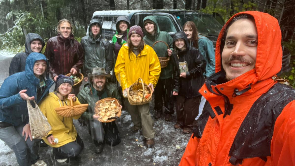 IFSA-OSU members with baskets of foraged mushrooms in a snowy forest