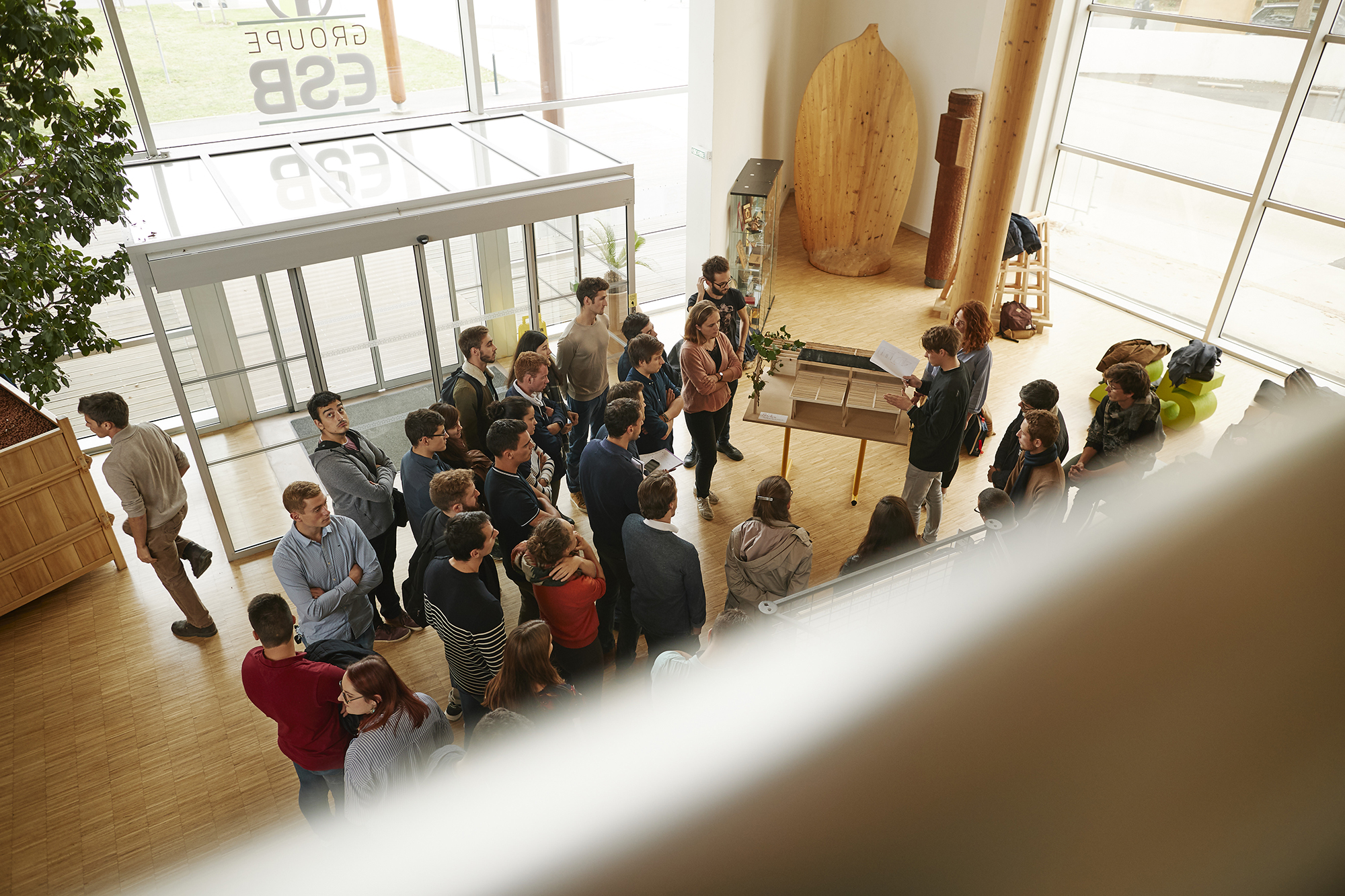 Wood and glass building with students