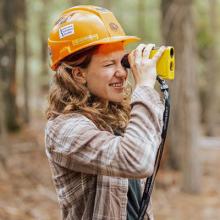 Researcher looks through binocular