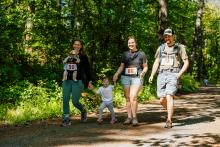 Family completing the Roots Run 5K in the McDonald Forest