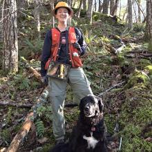 Abby Schroeder with her dog in the McDonald Forest