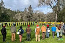 Participants in the IGNITE Prescribed Fire Skills Weekend form a circle for the morning briefing and welcome before breakout groups begin. 