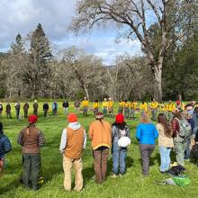 Participants in the IGNITE Prescribed Fire Skills Weekend form a circle for the morning briefing and welcome before breakout groups begin. 